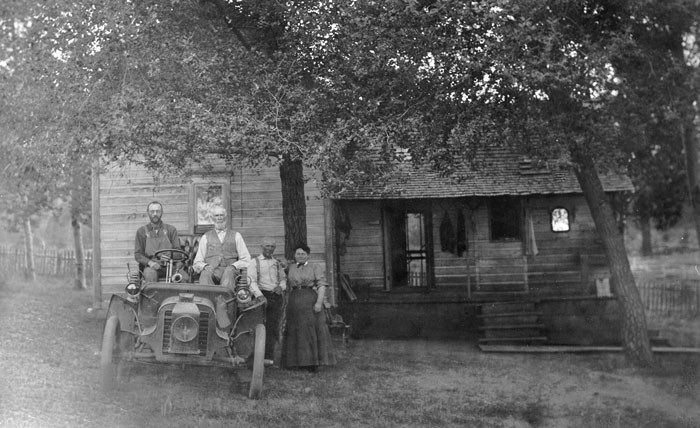 The Hindman home, viewed from the east. Left to right: Gust Olson, Samuel Hindman, Charley Hindman, Martha Taylor Cobb Hindman, and a 1903 Packard car (c. 1918). Photo: courtesy of Jan Hodgers.